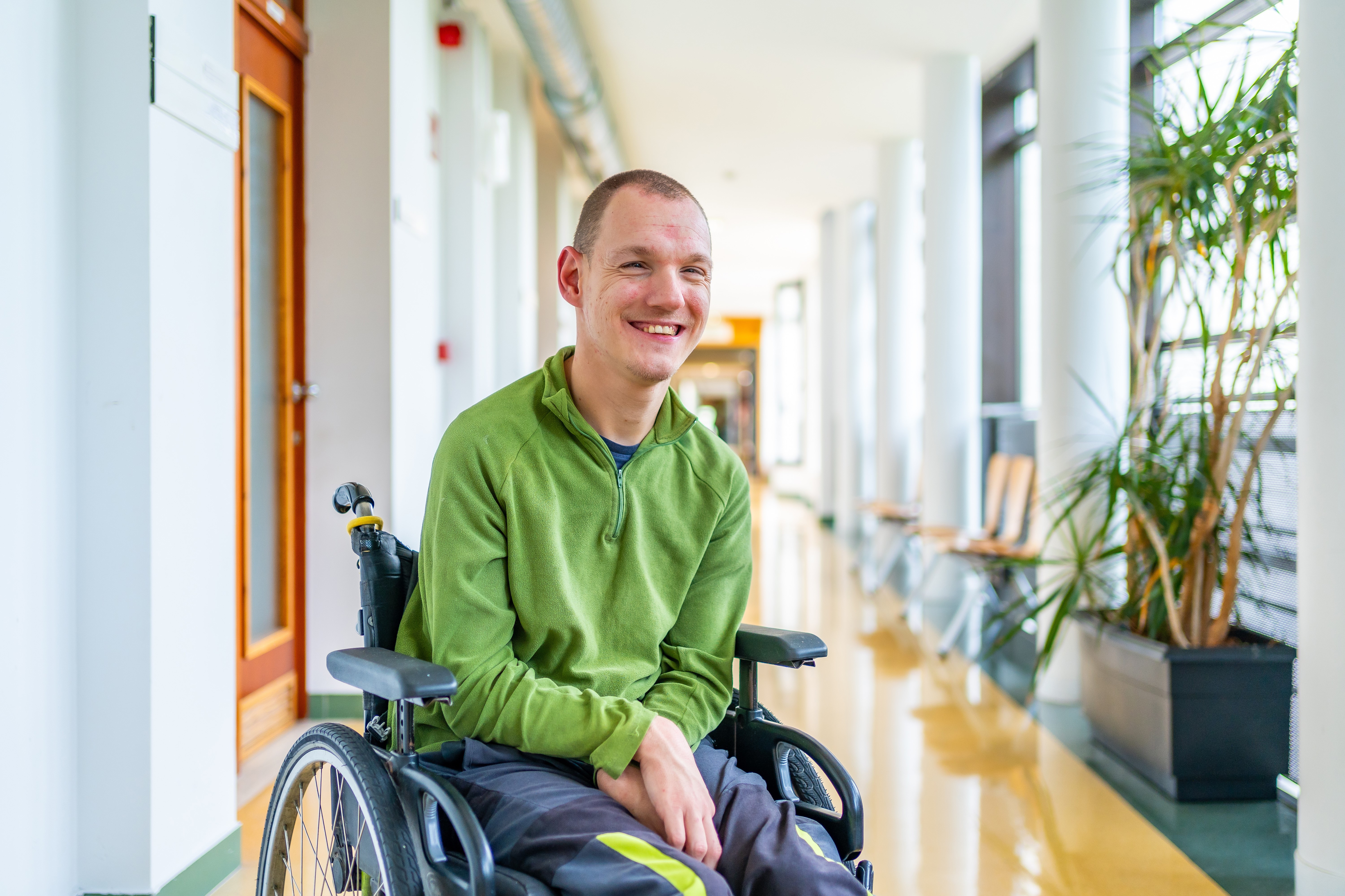 Young man in wheelchair smiling
